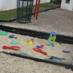 Sandbox with toys to share