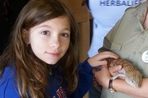 Amelia petting a reptile at Great Adventure's safari attraction